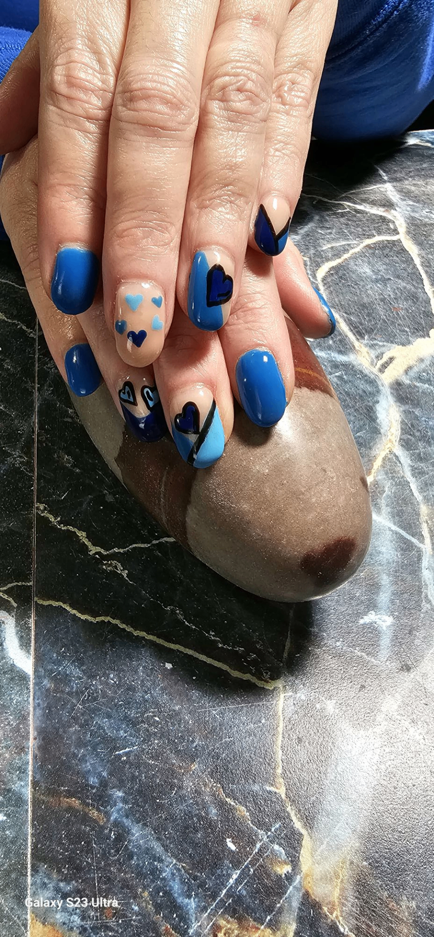 Blue hand-painted heart nail art by Lanette