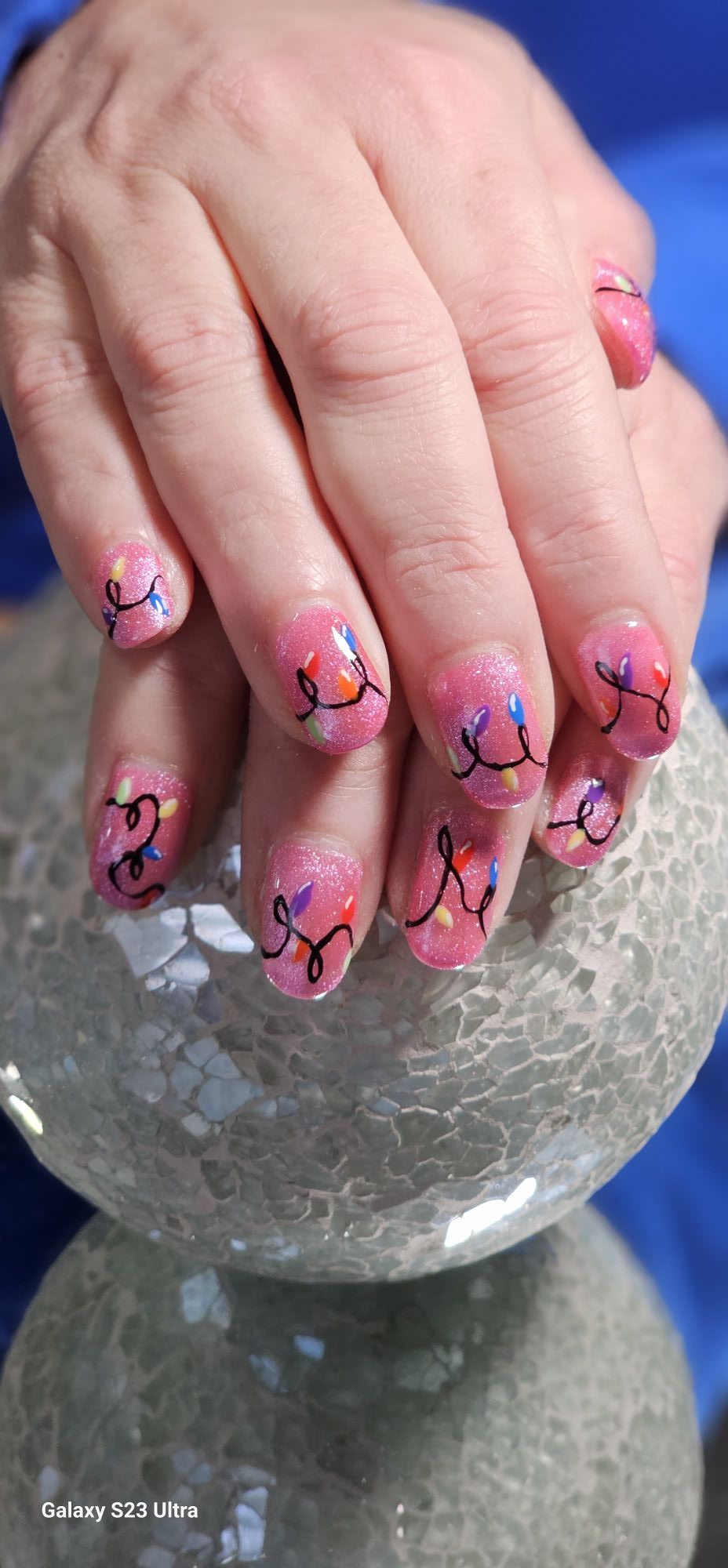 Pink shimmer nails with holiday lights art by Lanette
